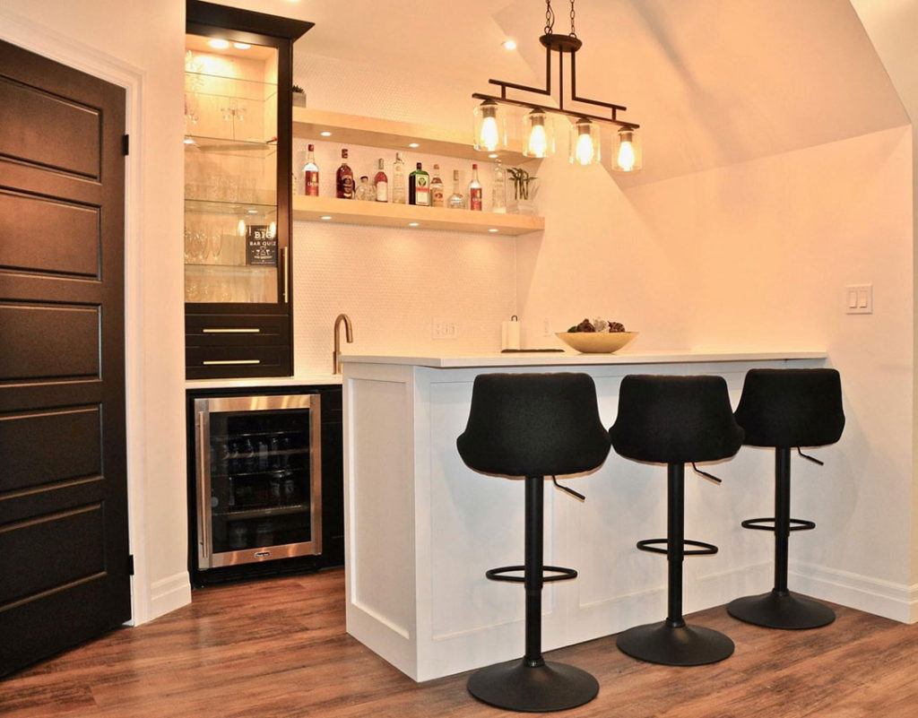 Finished basement with a custom bar by LIV4 Homes